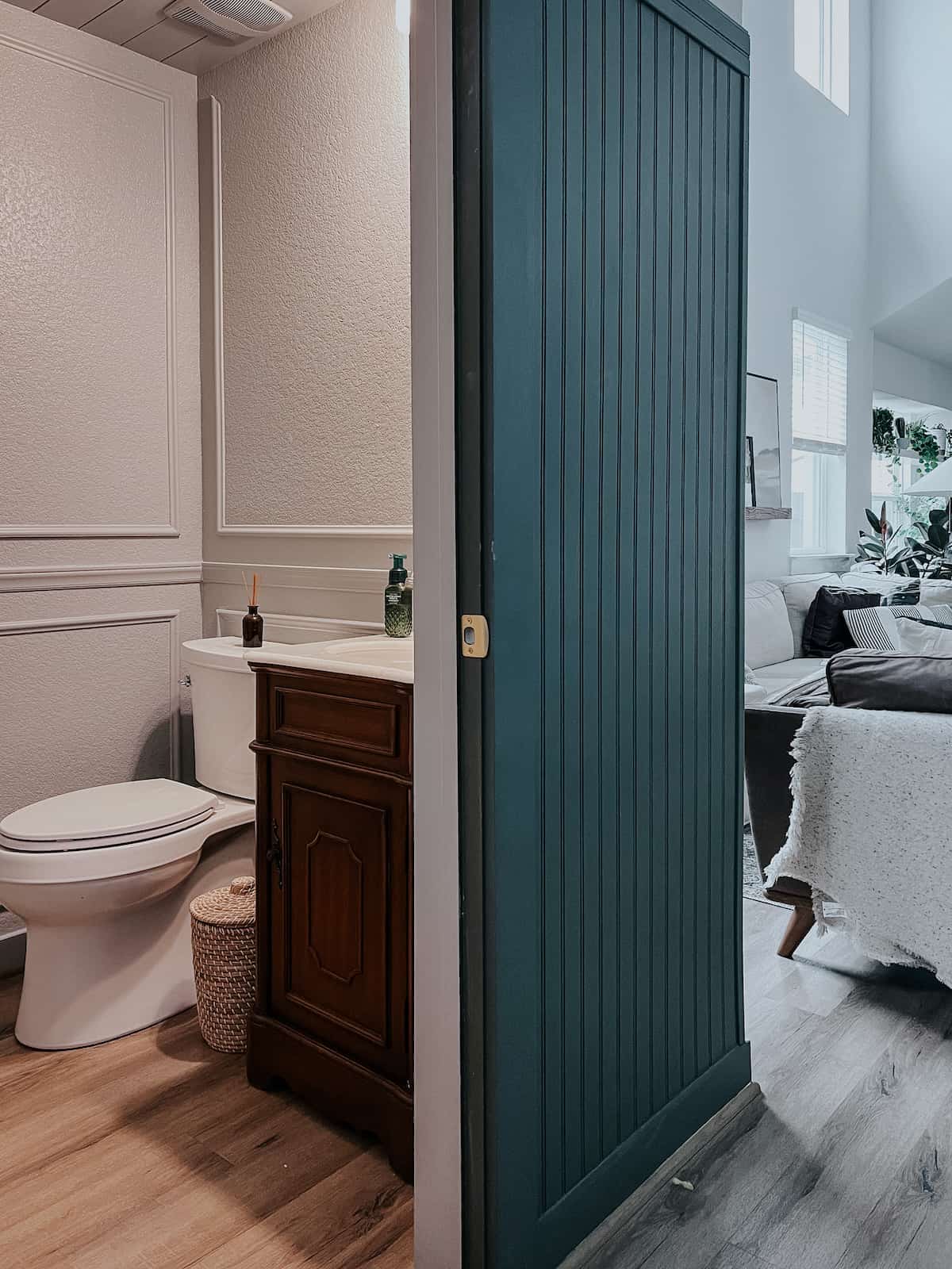 view of a small powder room under a staircase