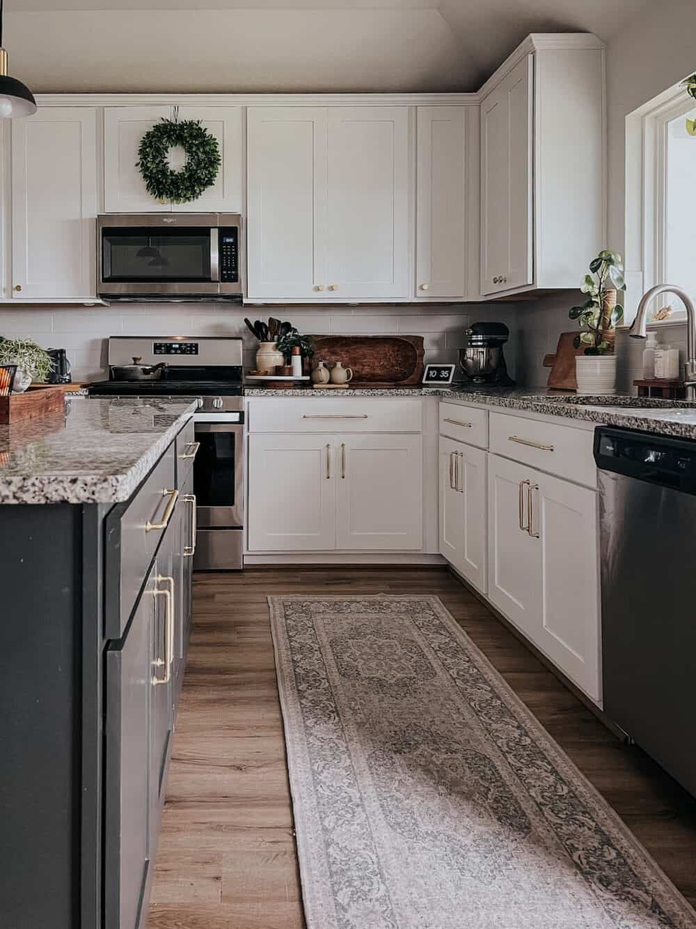 kitchen with white cabinetry and a black kitchen island 