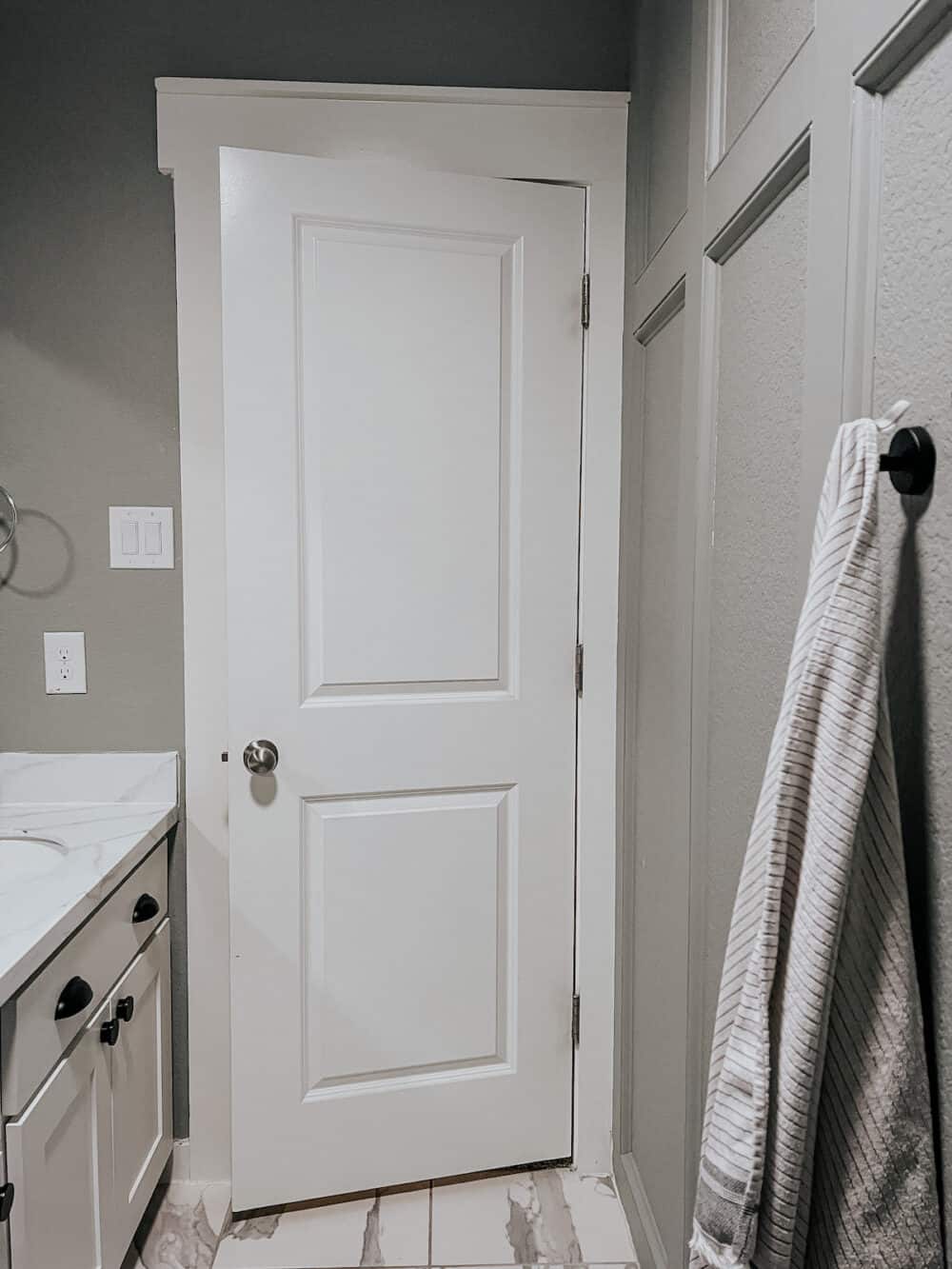 bathroom with trim treatment on one wall 