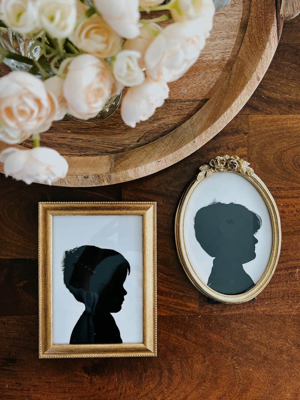two silhouette prints of young children laying on a table 