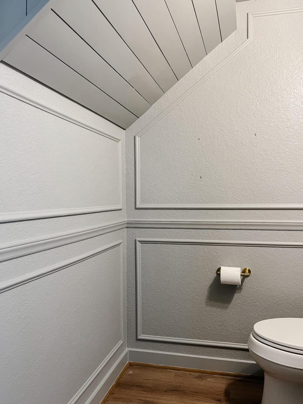 powder room with gray walls and picture molding 