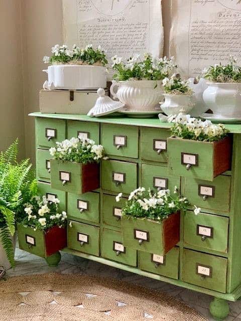 dresser with soup tureens turned into planters 