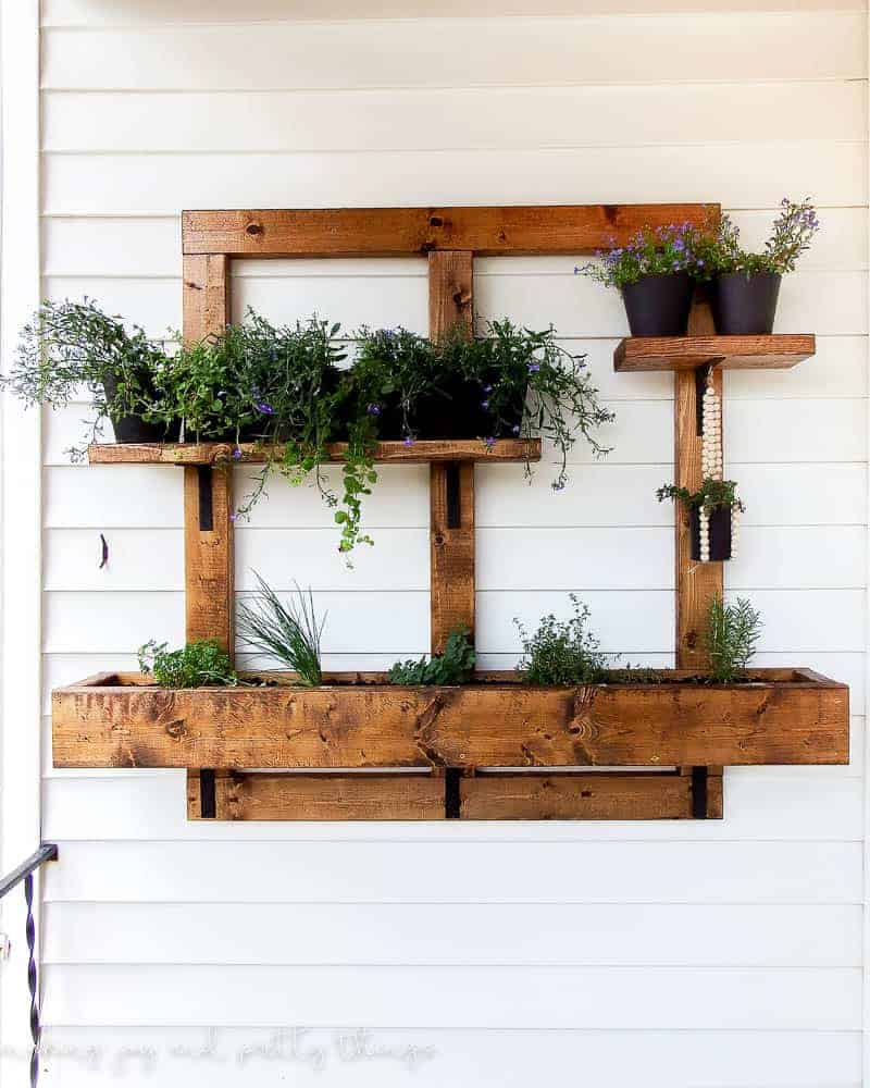 vertical herb garden hanging on the side of a house 