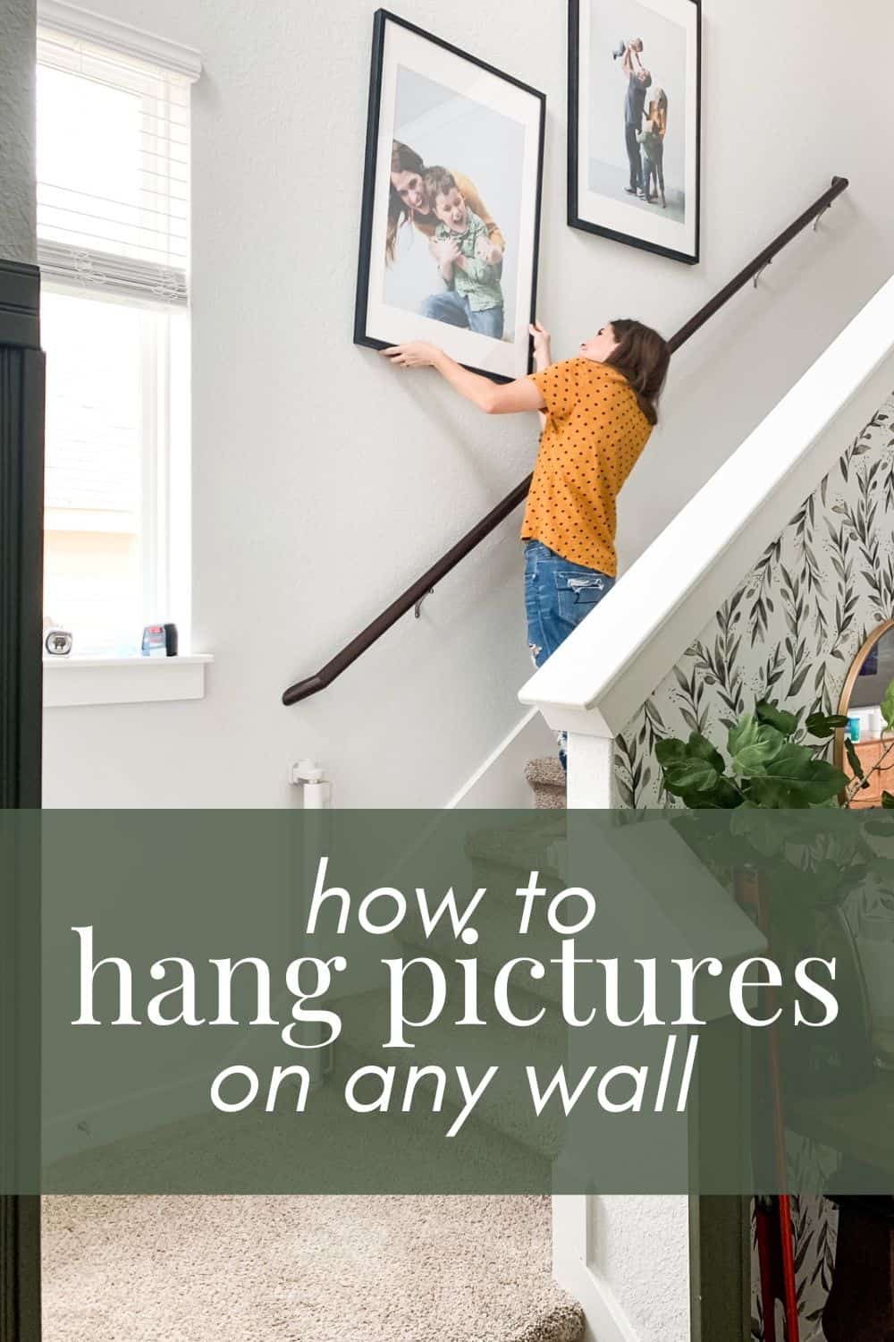 woman hanging a large art piece with text overlay - how to hang pictures on any wall 