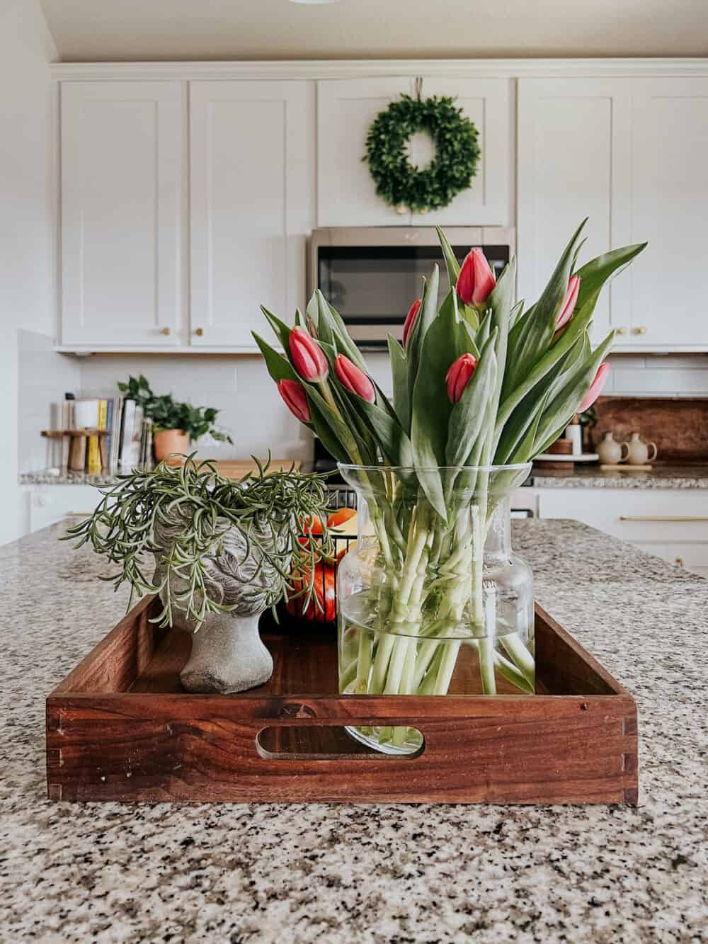 Kitchen island with fresh tulips and a bust planter 