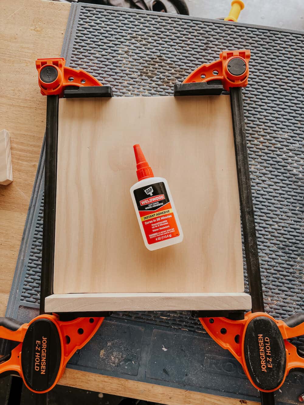 wood clamped together with weldwood instant wood adhesive sitting on it 