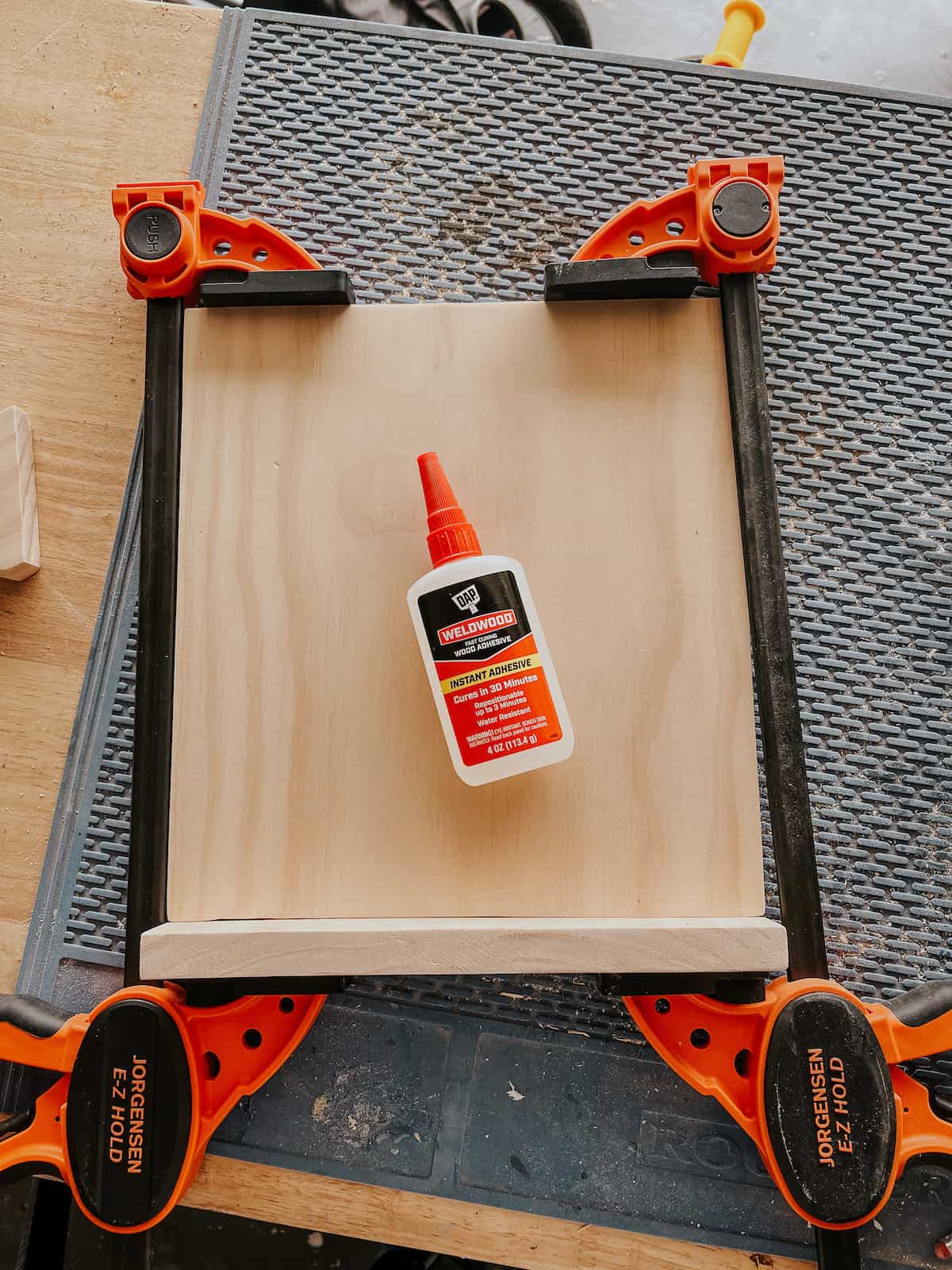 pieces of DIY cookbook holder being assembled, with Weldwood wood adhesive sitting on top