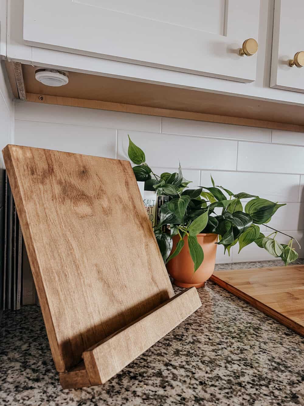 simple diy wooden cookbook holder sitting on a kitchen counter 