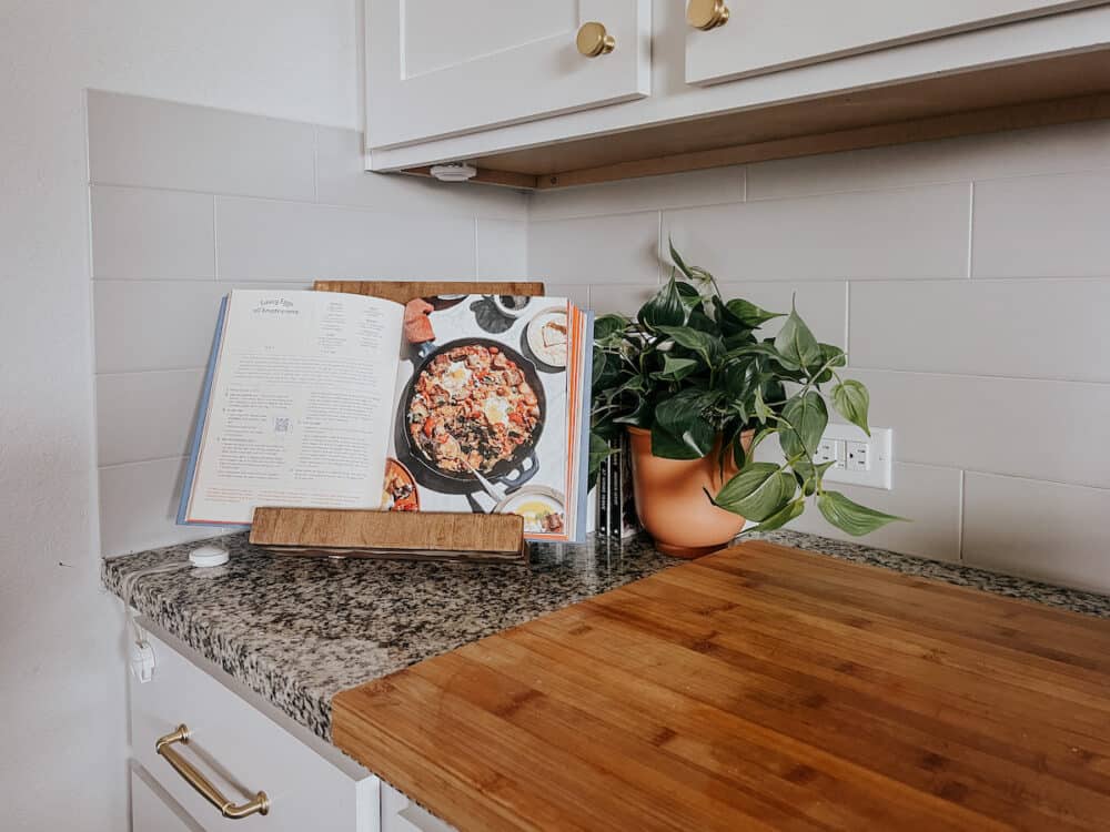 DIY wooden cookbook stand sitting on a kitchen counter 