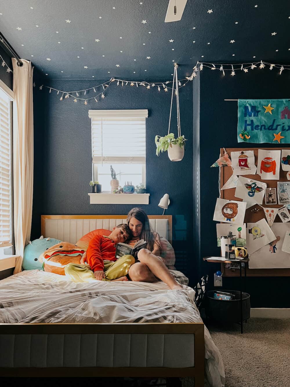 kid room with a full sized bed frame 