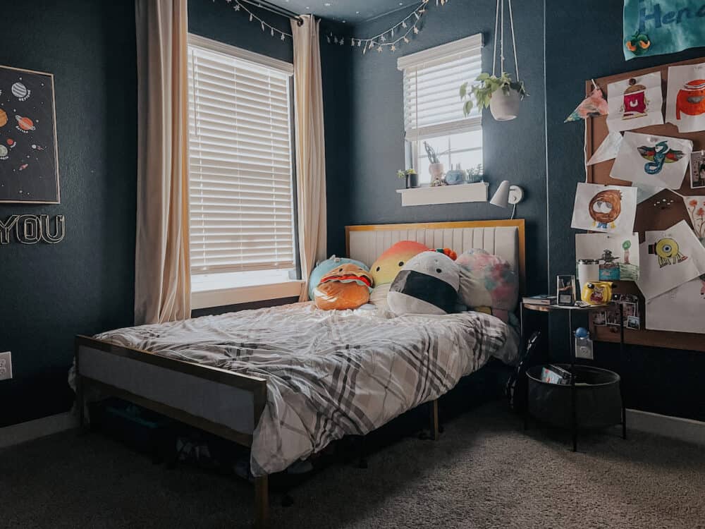 dark blue kid room with a full sized bed frame 