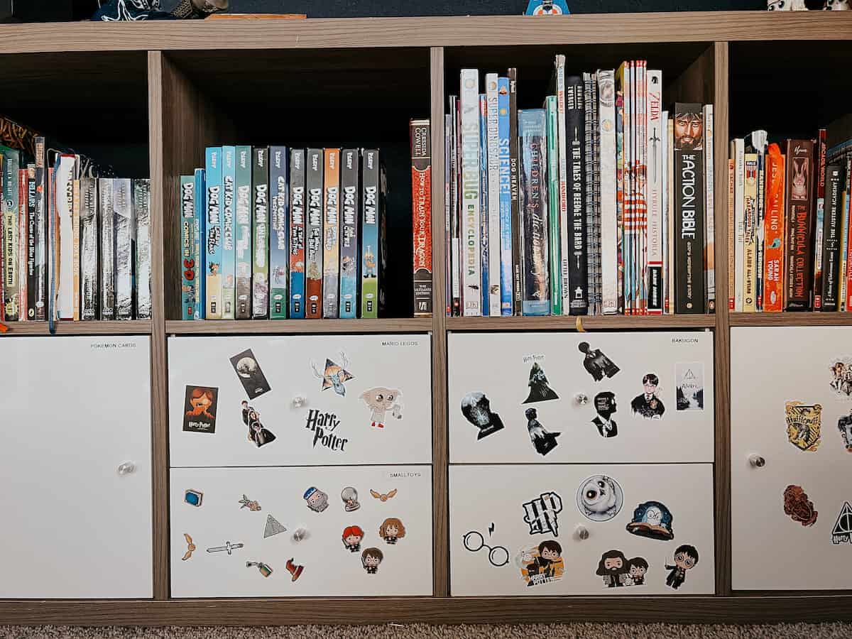 A kid's storage unit with labels on drawers 