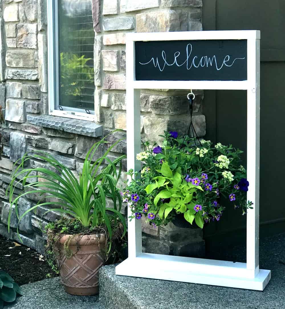 plant stand welcome sign