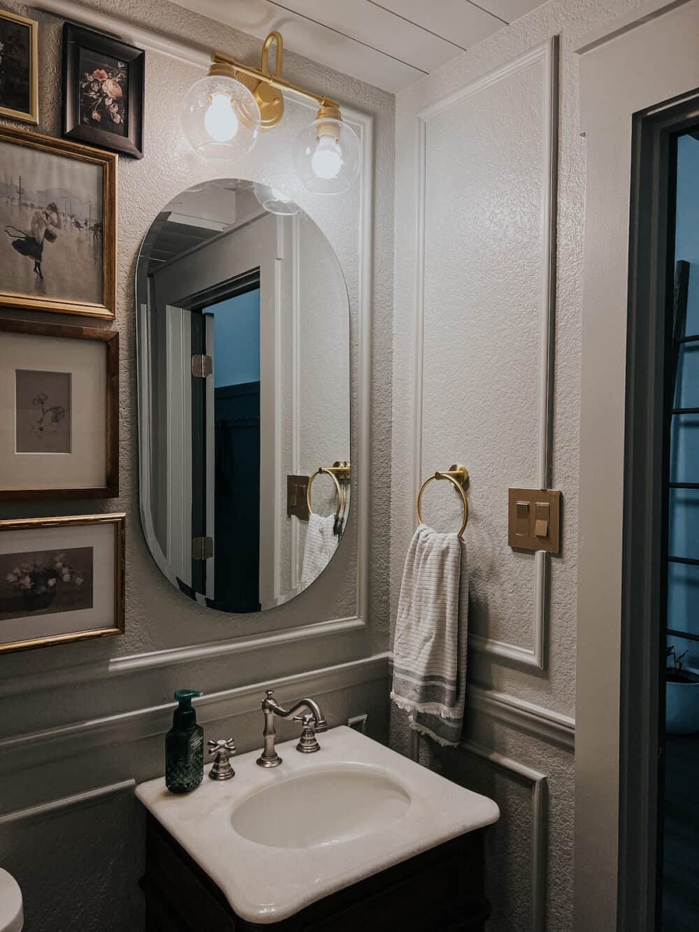 powder room vanity, mirror, and light 