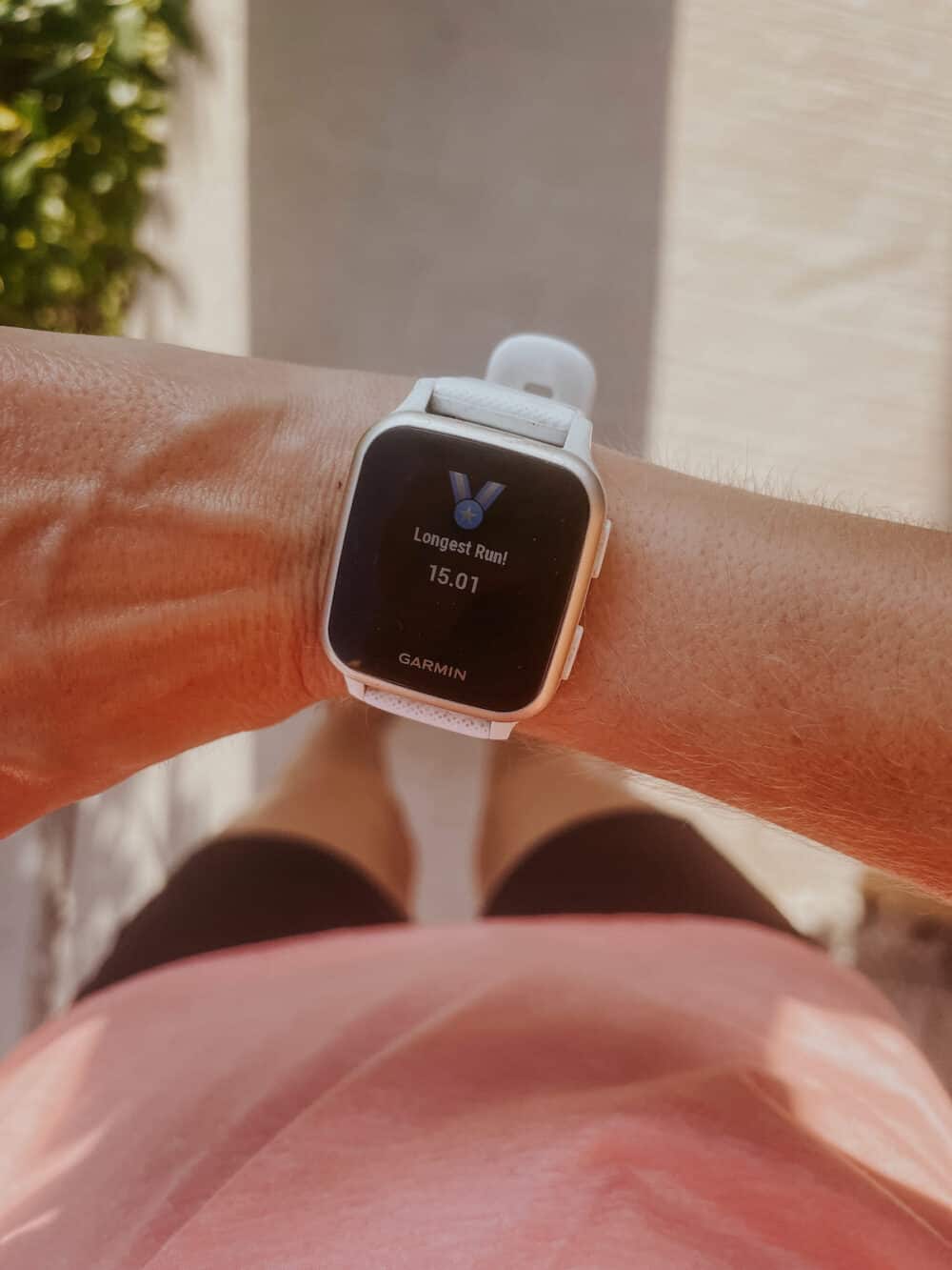 A running watch showing a longest run medal