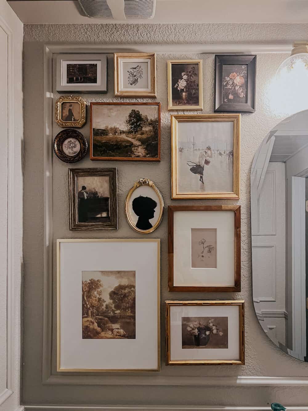 a gallery wall of small photos hung in a powder room 