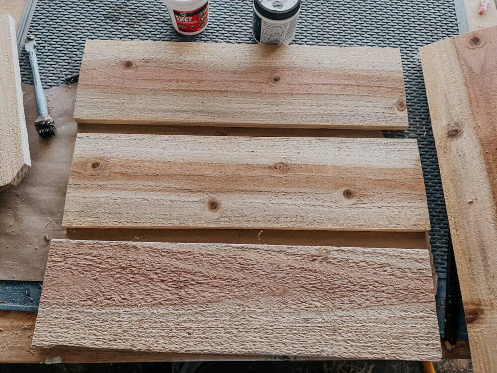 three pieces of cedar fence board. cut for window box 