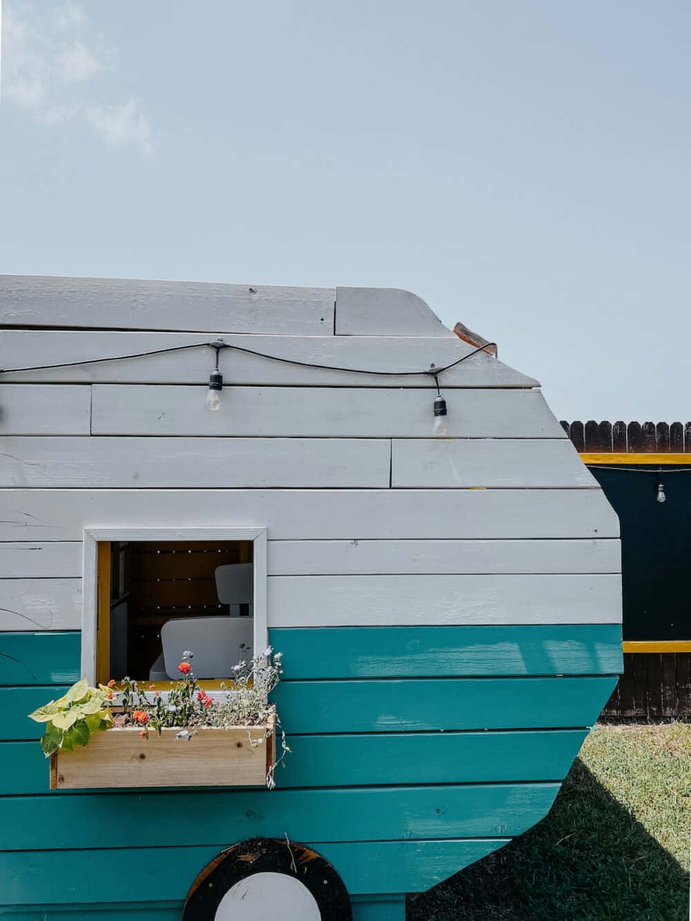 Play house with a window box under the window 