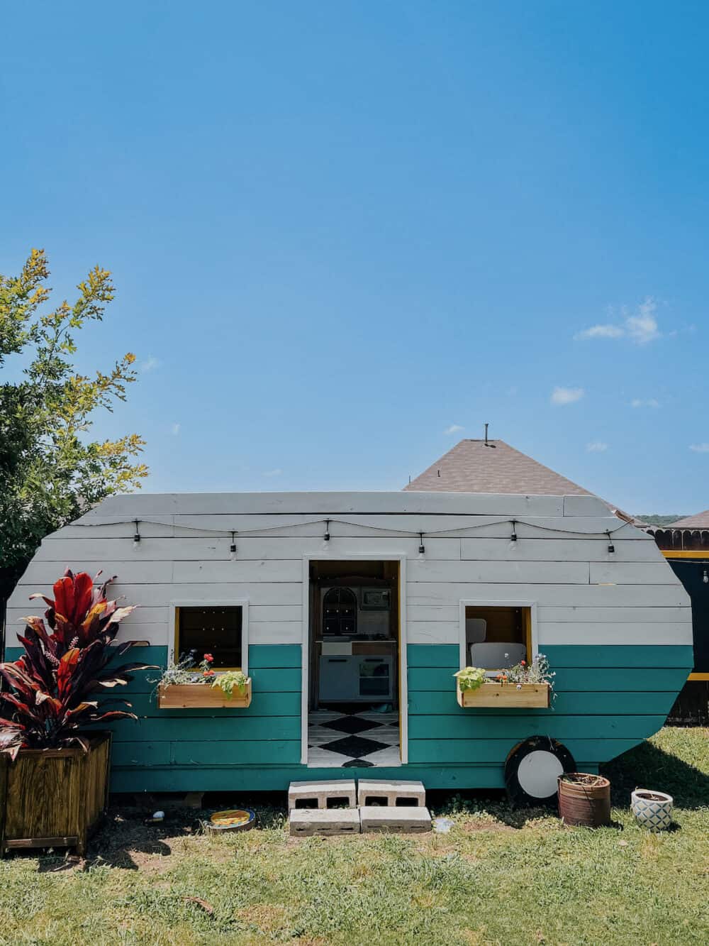 backyard playhouse camper with window boxes 