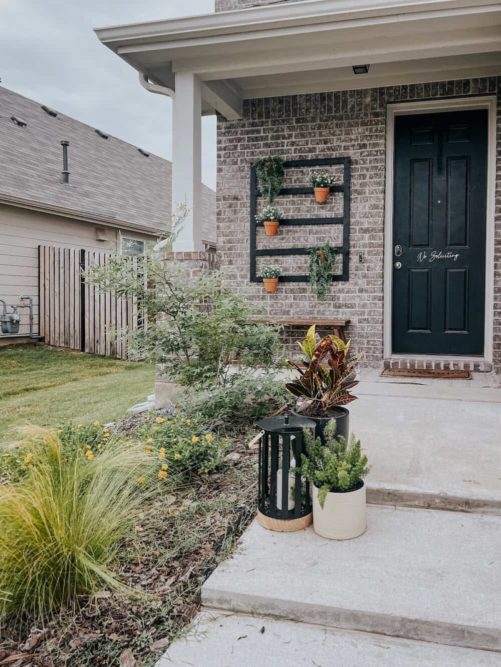 small suburban front porch with a plant wall 