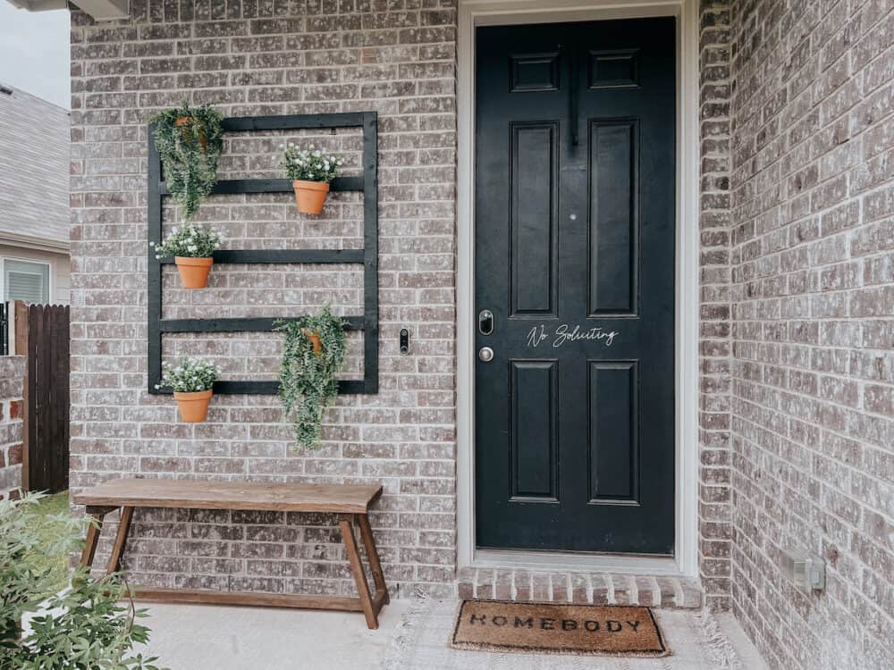 front porch with black plant hanger 