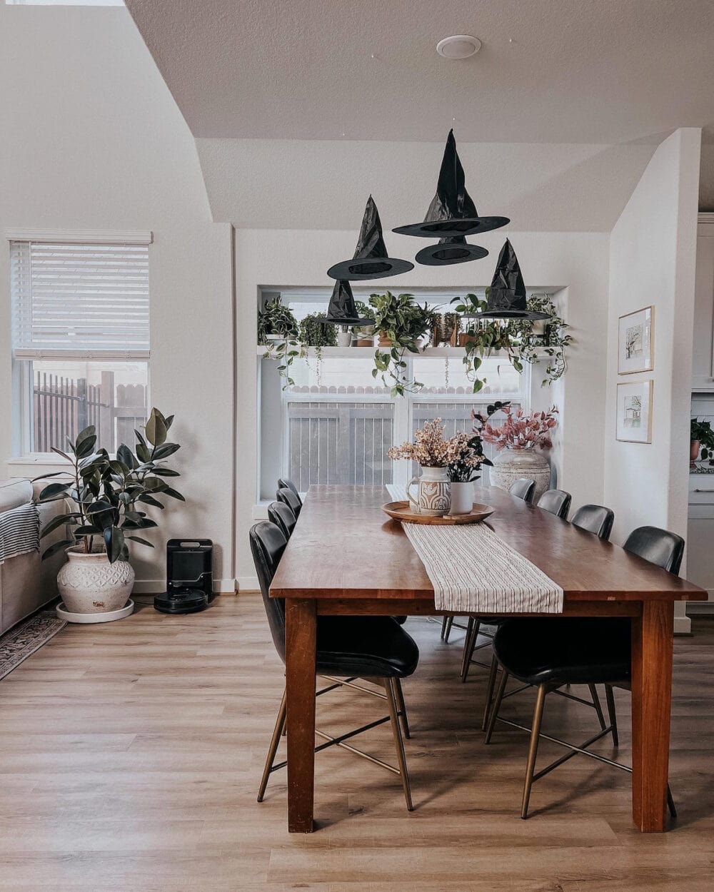 Dining room with witch's hats hanging from the ceiling 