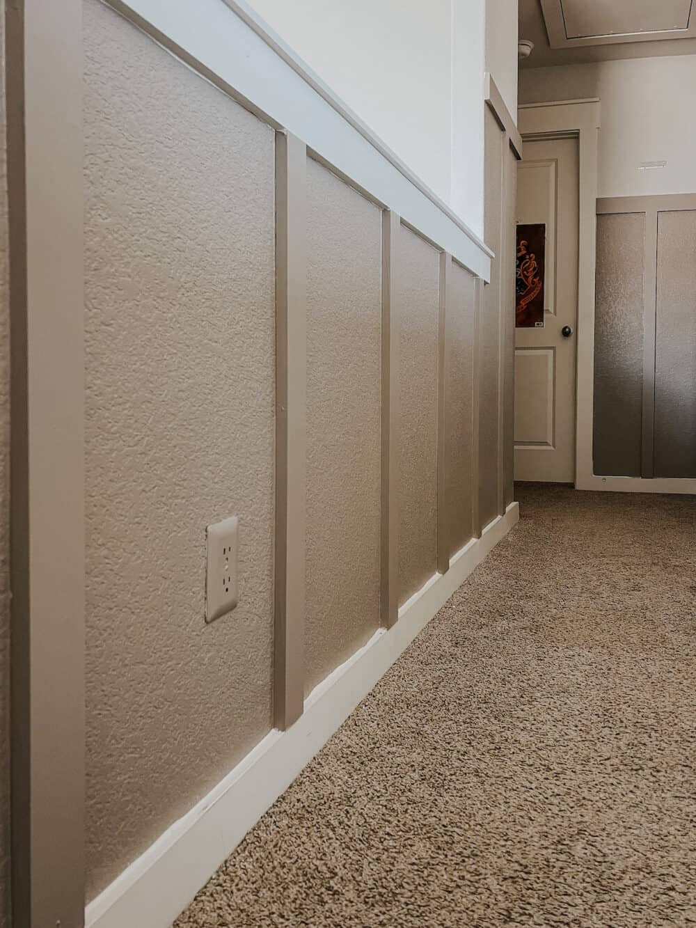 a paintable outlet cover that blends right into a hallway painted a saturated color