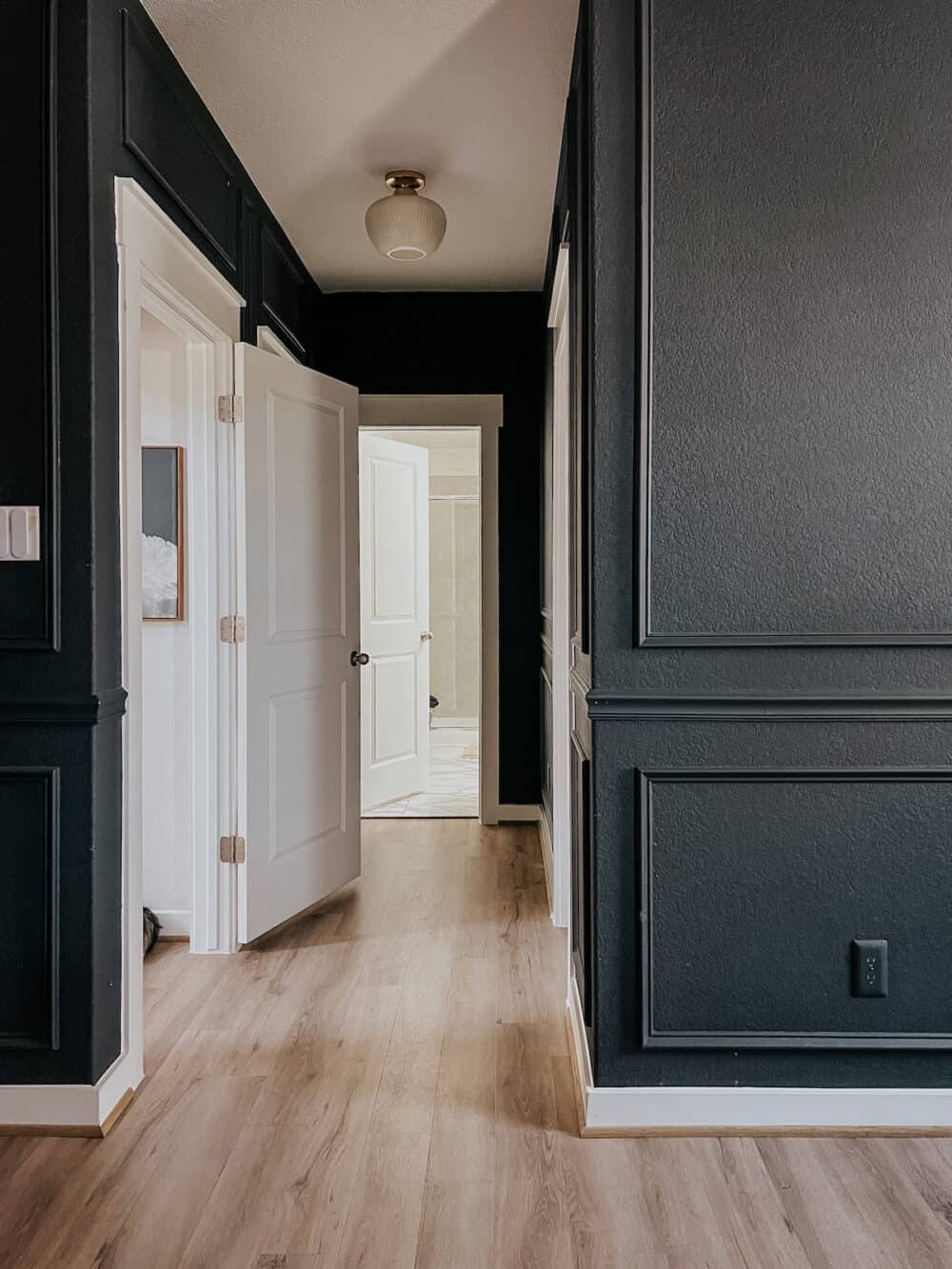 bedroom with dark blue walls and picture molding trim