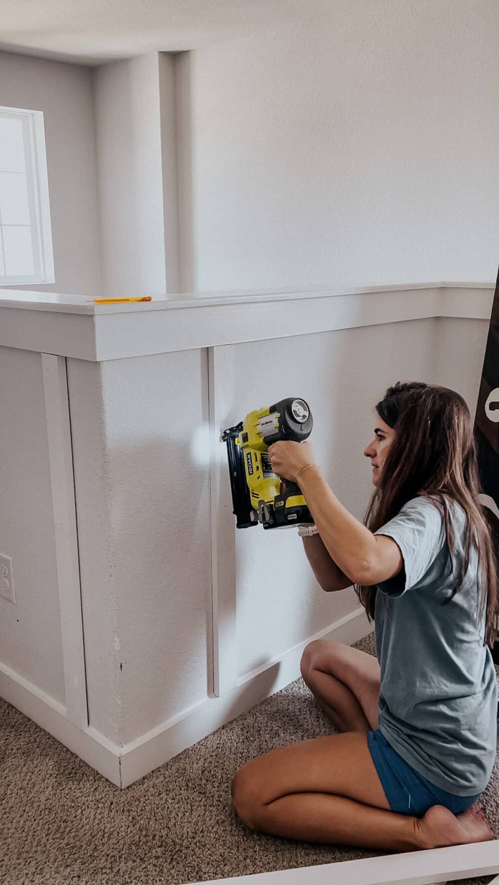 woman installing board and batten