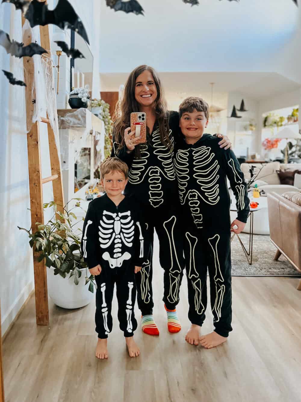 mother and two boys in matching skeleton pajamas