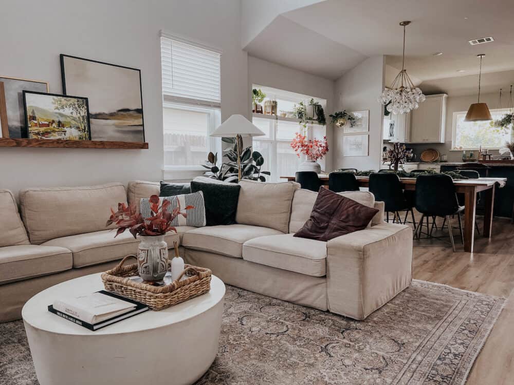 neutral great room with a sectional sofa and large dining table 