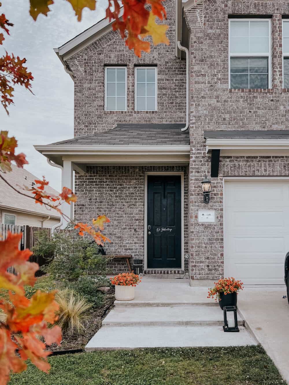 exterior of a brick home in a suburban neighborhood 