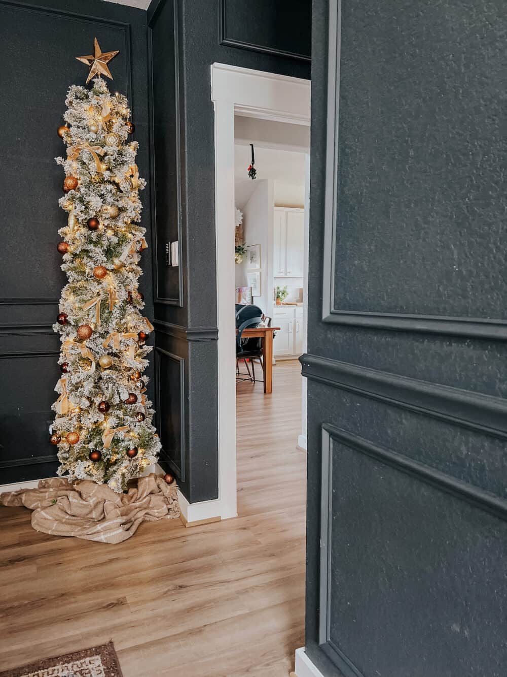 tall and skinny Christmas tree in a bedroom 