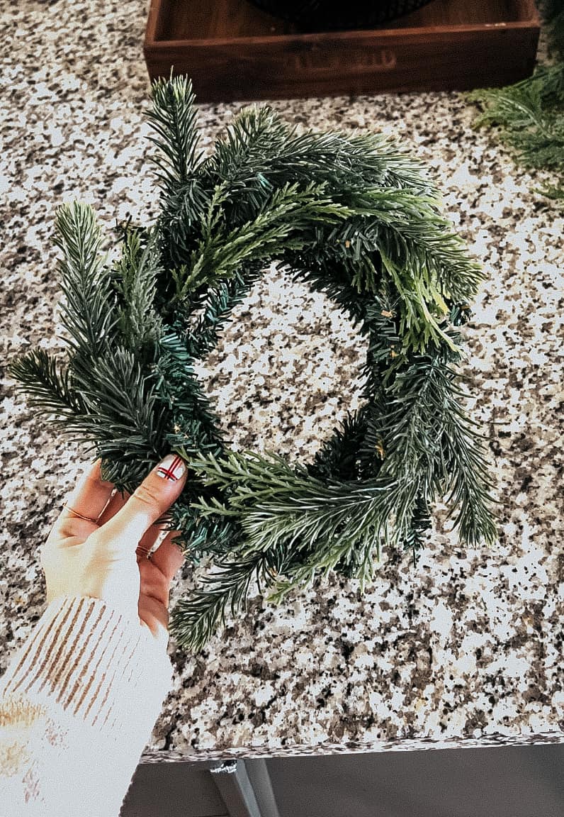 woman's hand holding a mini wreath