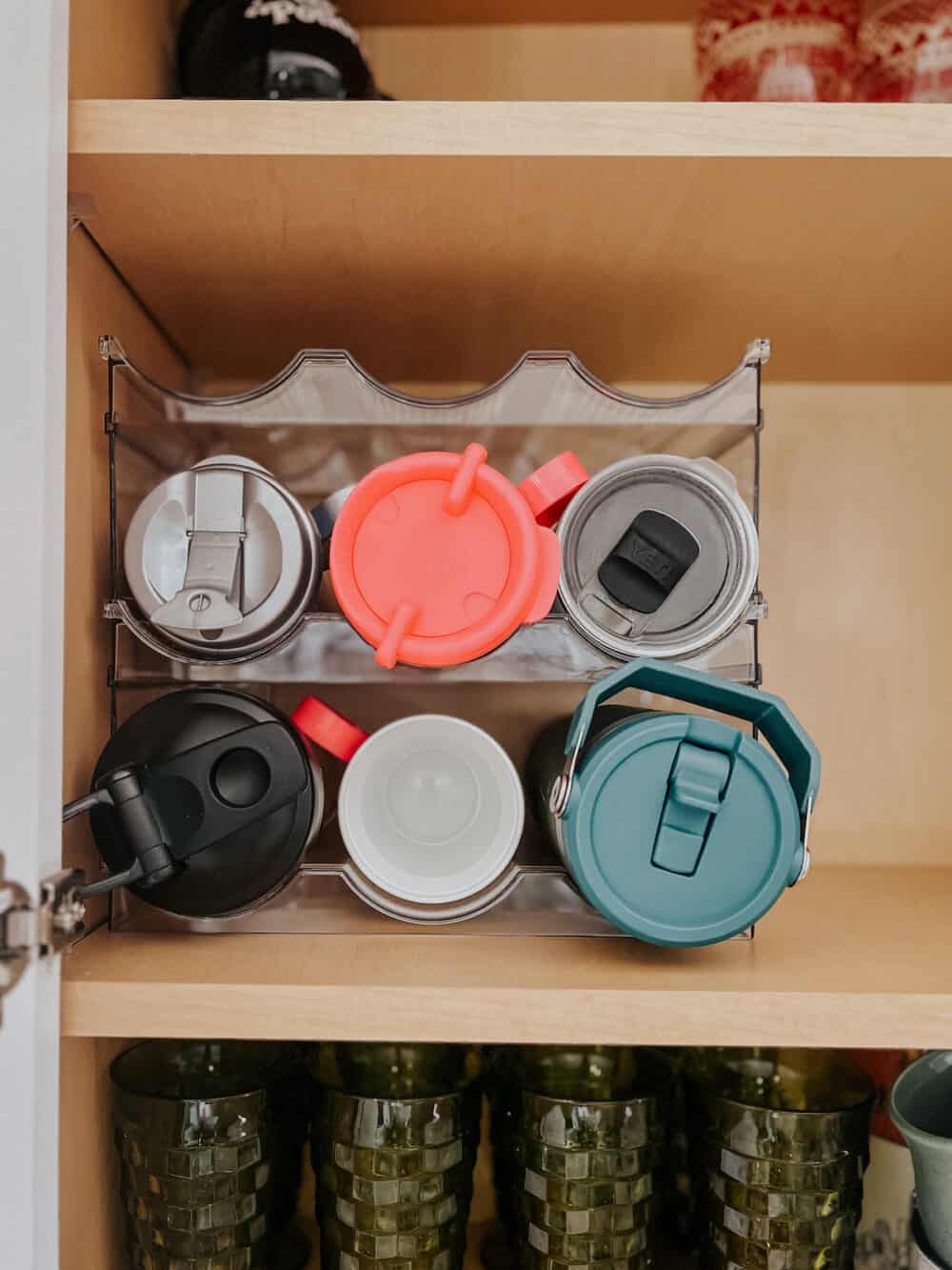 Water bottle organizer in a cup cabinet