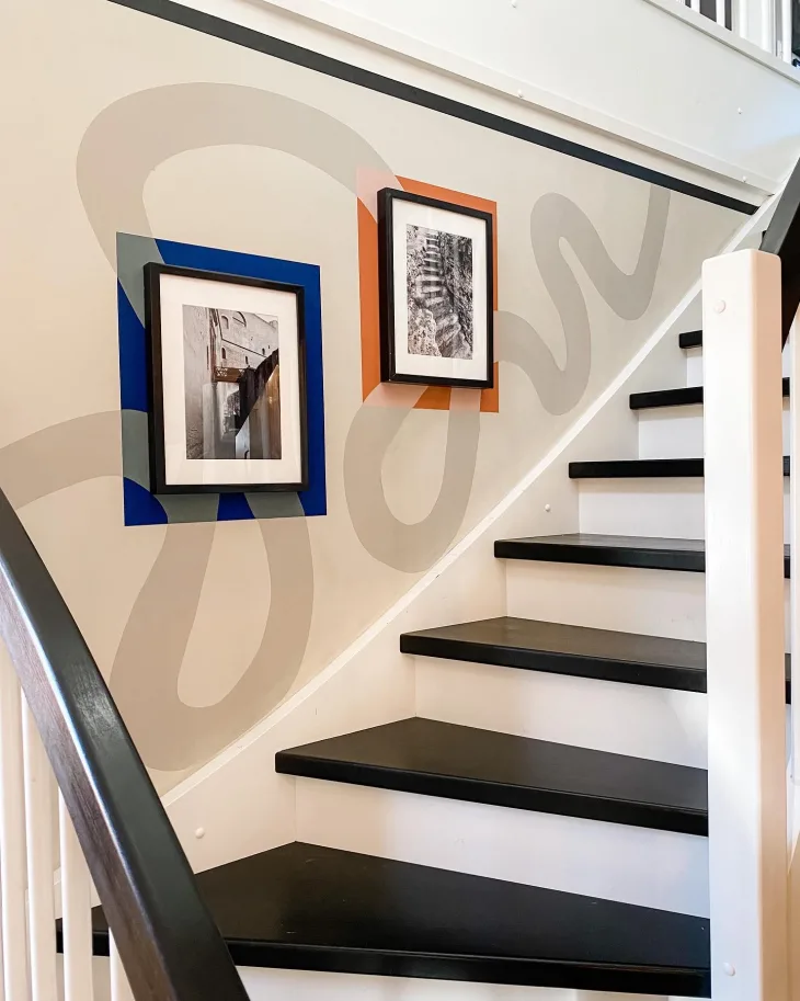 a staircase with a small mural painted on it