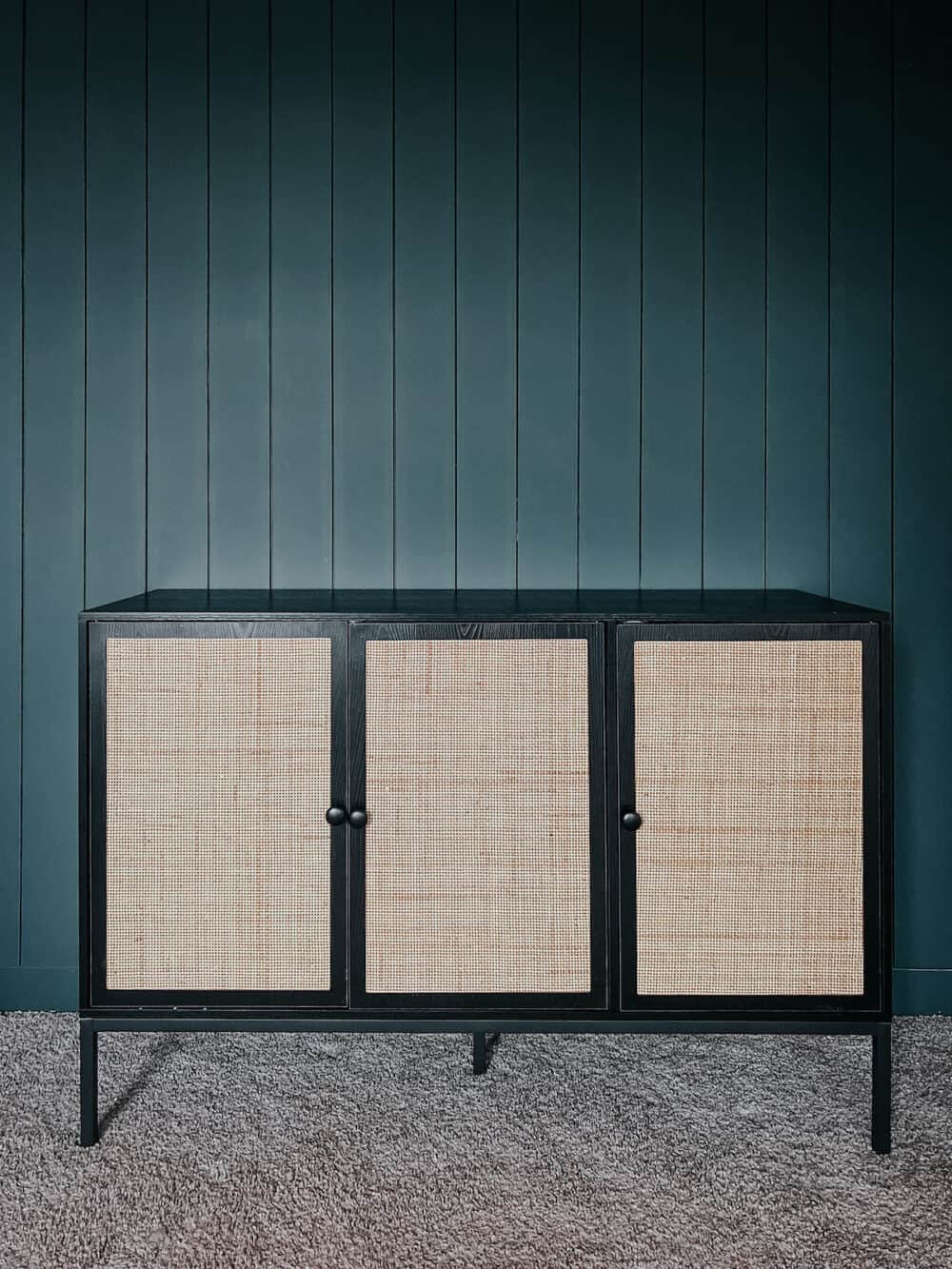 amazon sideboard on a dark green shiplap wall 