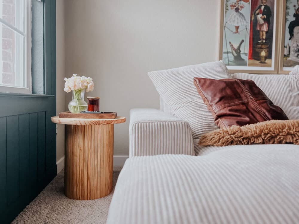 a cozy couch with a DIY fluted side table next to it