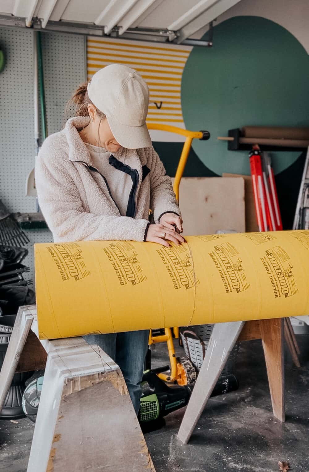 woman using a utility knife to cut a concrete form 