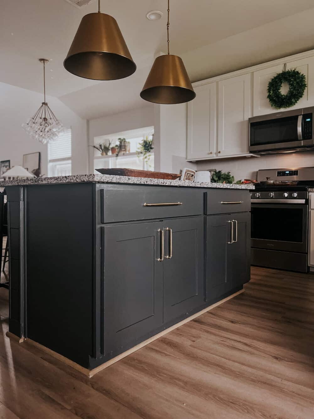 kitchen with white cabinets and a black painted island 