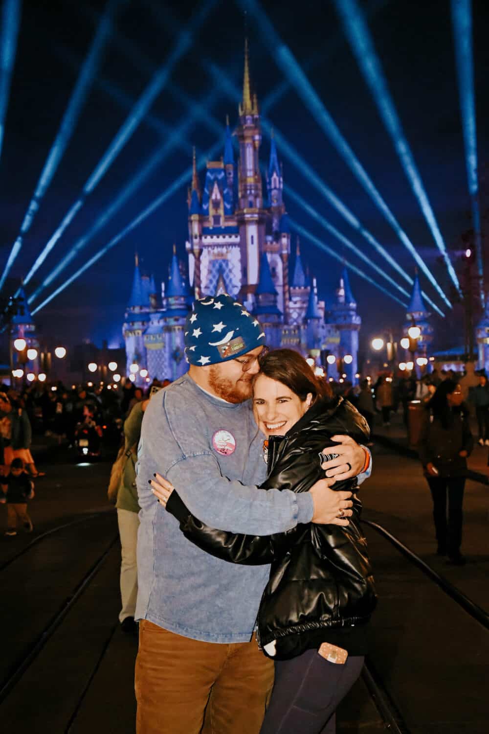 a couple posing in from of Cinderella's Castle at Disney World 