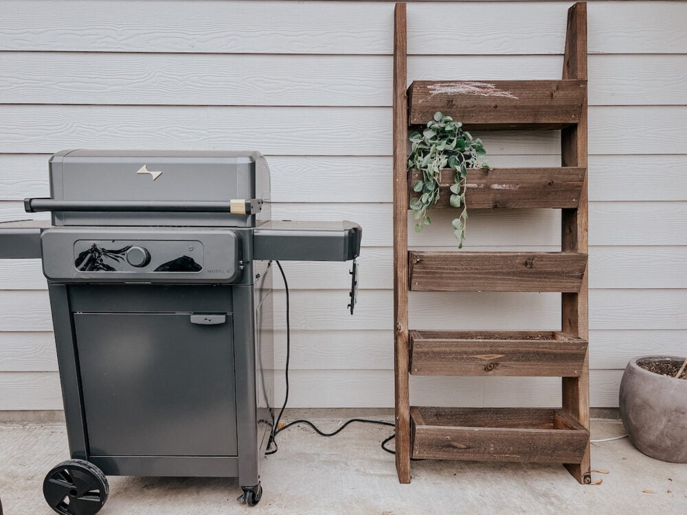 Current Dual Zone electric grill sitting on a back patio