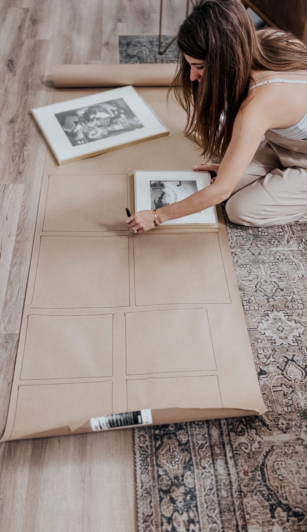 woman cutting frame shapes out of butcher paper 