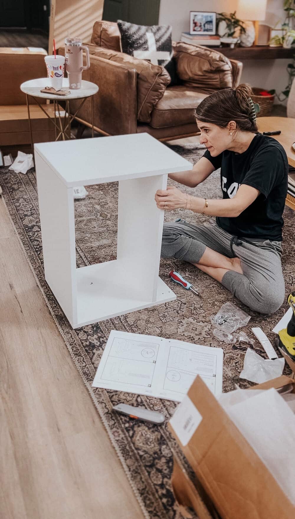 woman assembling a Modular Closets system 