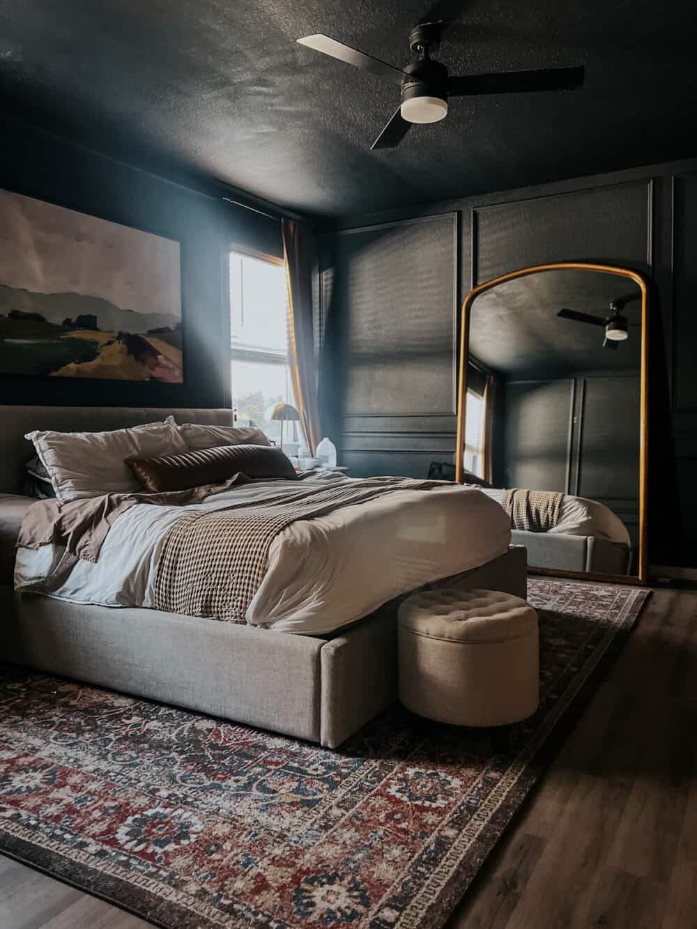 bedroom with dark blue walls and ceiling and picture molding 
