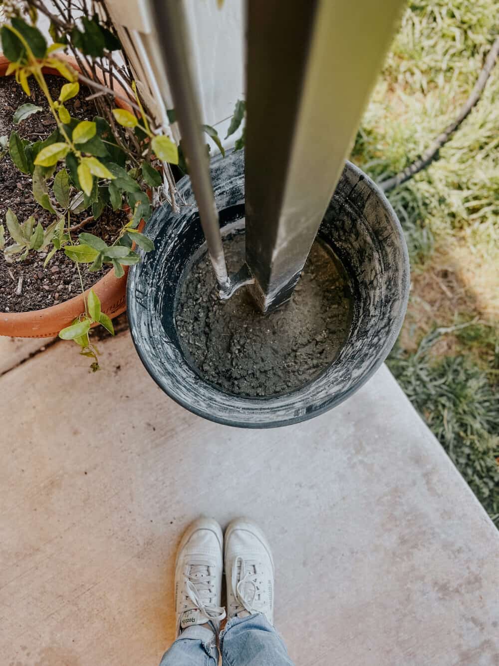 plastic planter with concrete to hold pergola in place