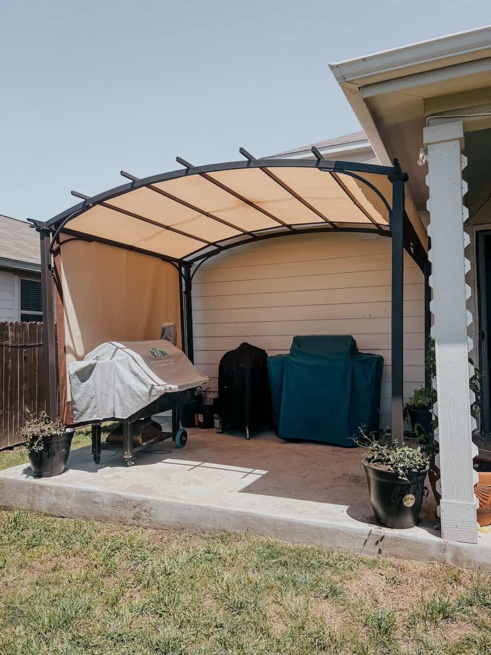 back patio with a large pergola on it 