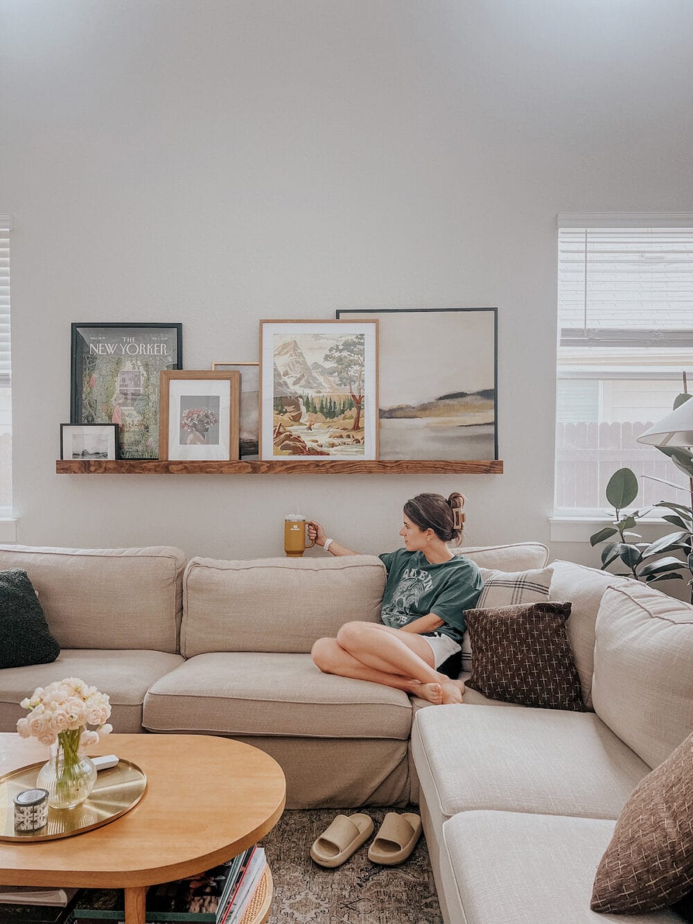 woman sitting on sofa using DIY sofa table to set down drink