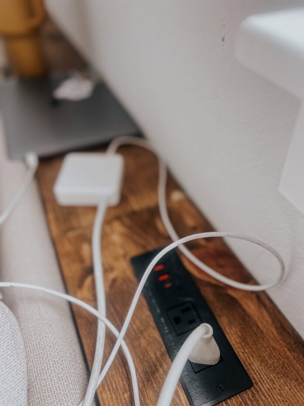 close up of recessed plugs on a behind the. couch table