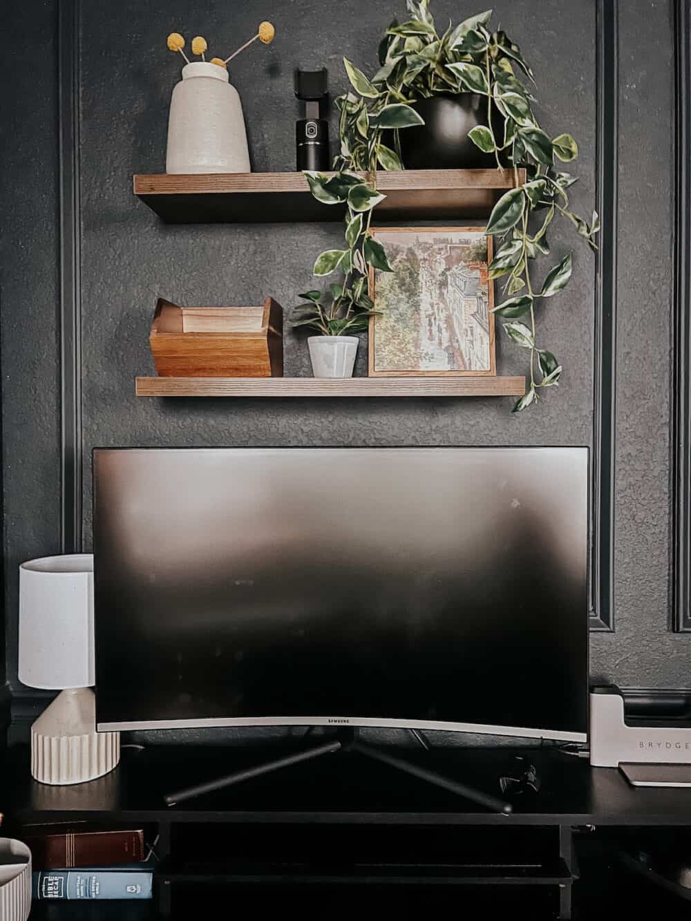 close up of a bedroom with a home office, and floating shelves